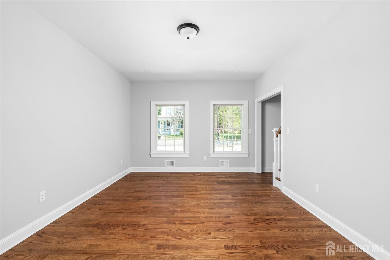 440 Ellisdale Road Chesterfield, NJ 08515 - Photo 7 of 42 an empty room with wooden floor and windows
