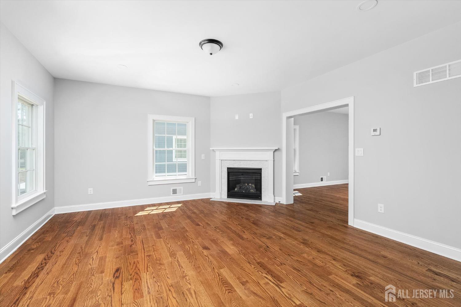 440 Ellisdale Road Chesterfield, NJ 08515 - Photo 8 of 42 a view of empty room with wooden floor and fireplace