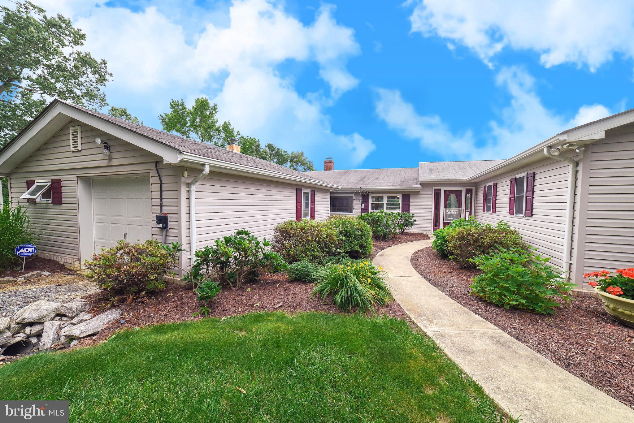 16215 Osprey Cove Ln Ridge Ridge, MD 20680 - Photo 11 of 30 a front view of a house with garden