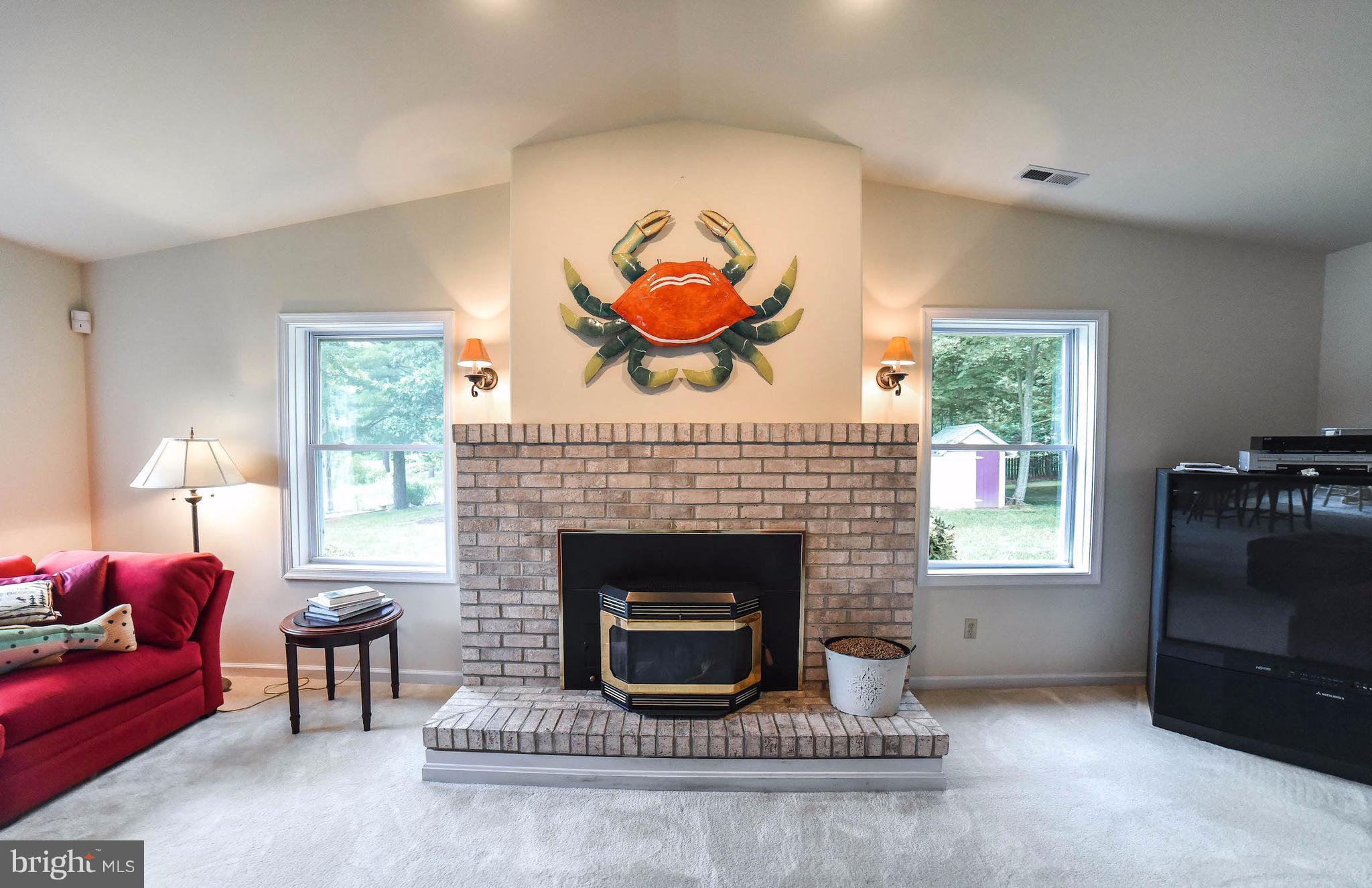 16215 Osprey Cove Ln Ridge Ridge, MD 20680 - Photo 14 of 30 a living room with furniture a window and a fireplace