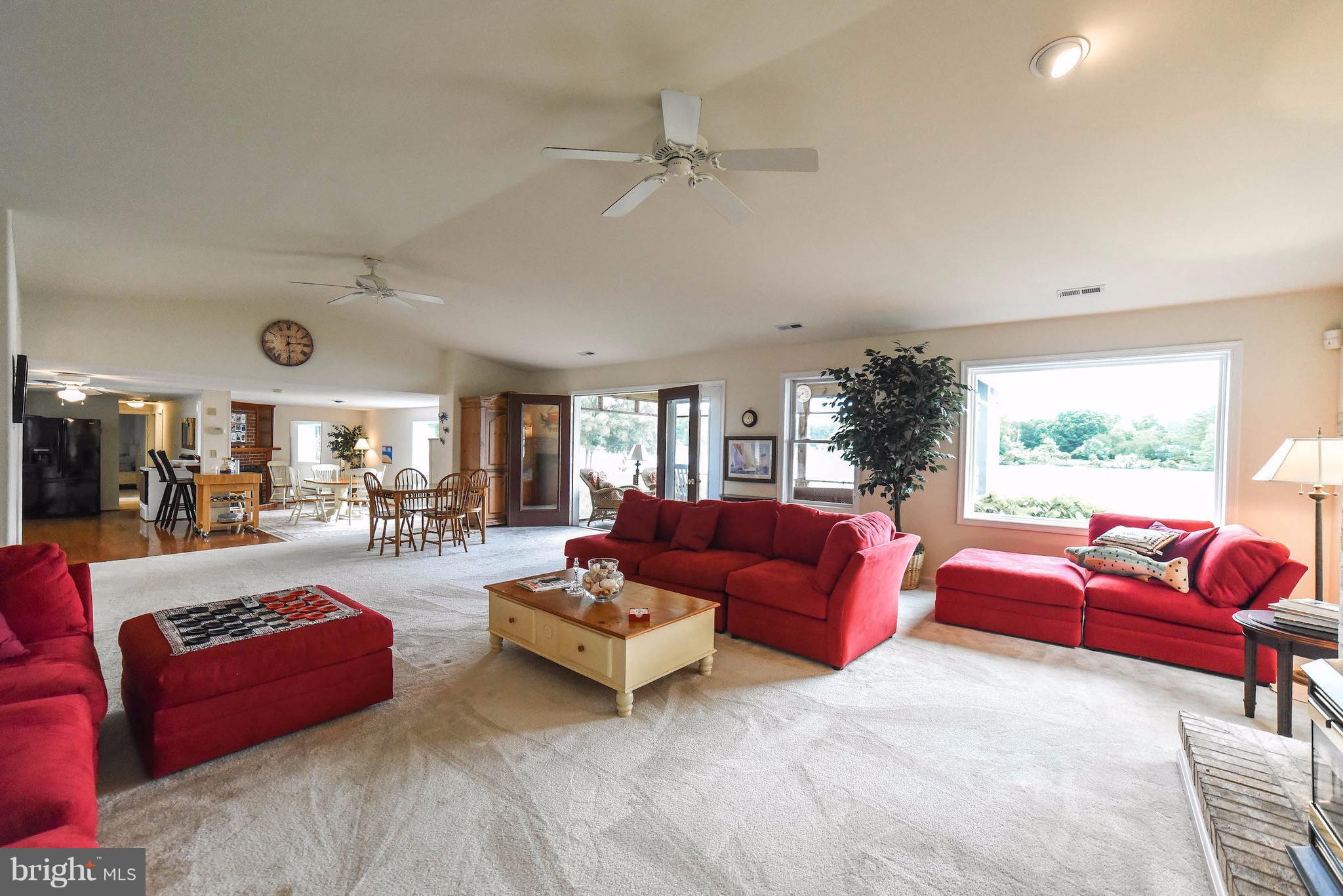 16215 Osprey Cove Ln Ridge Ridge, MD 20680 - Photo 15 of 30 a living room with furniture and a large window