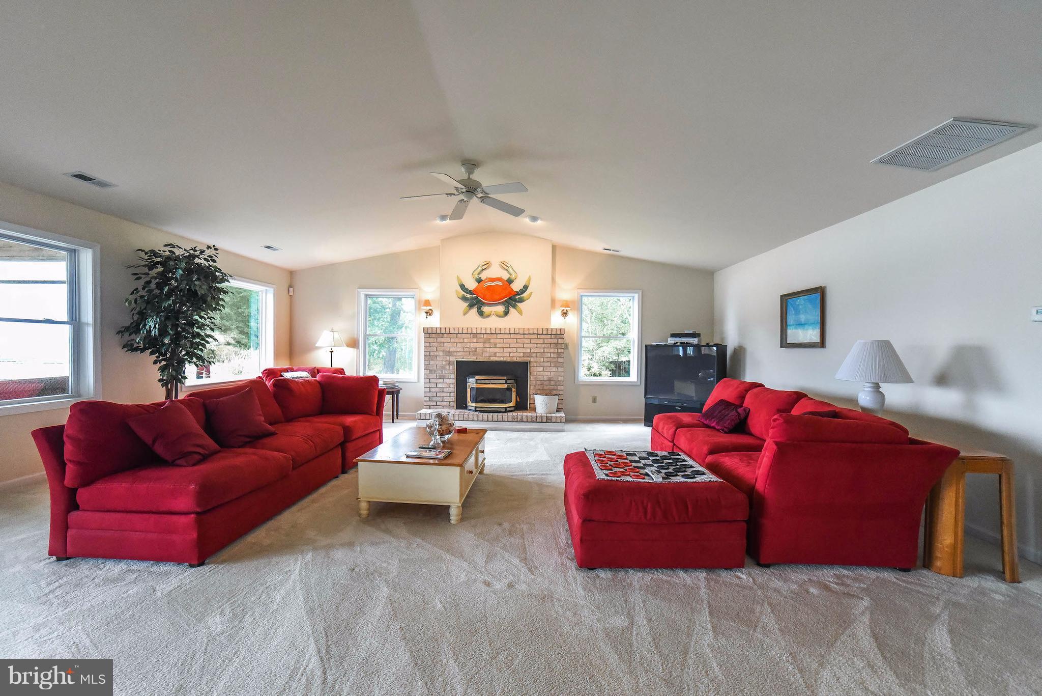 16215 Osprey Cove Ln Ridge Ridge, MD 20680 - Photo 16 of 30 a living room with furniture fireplace and a window