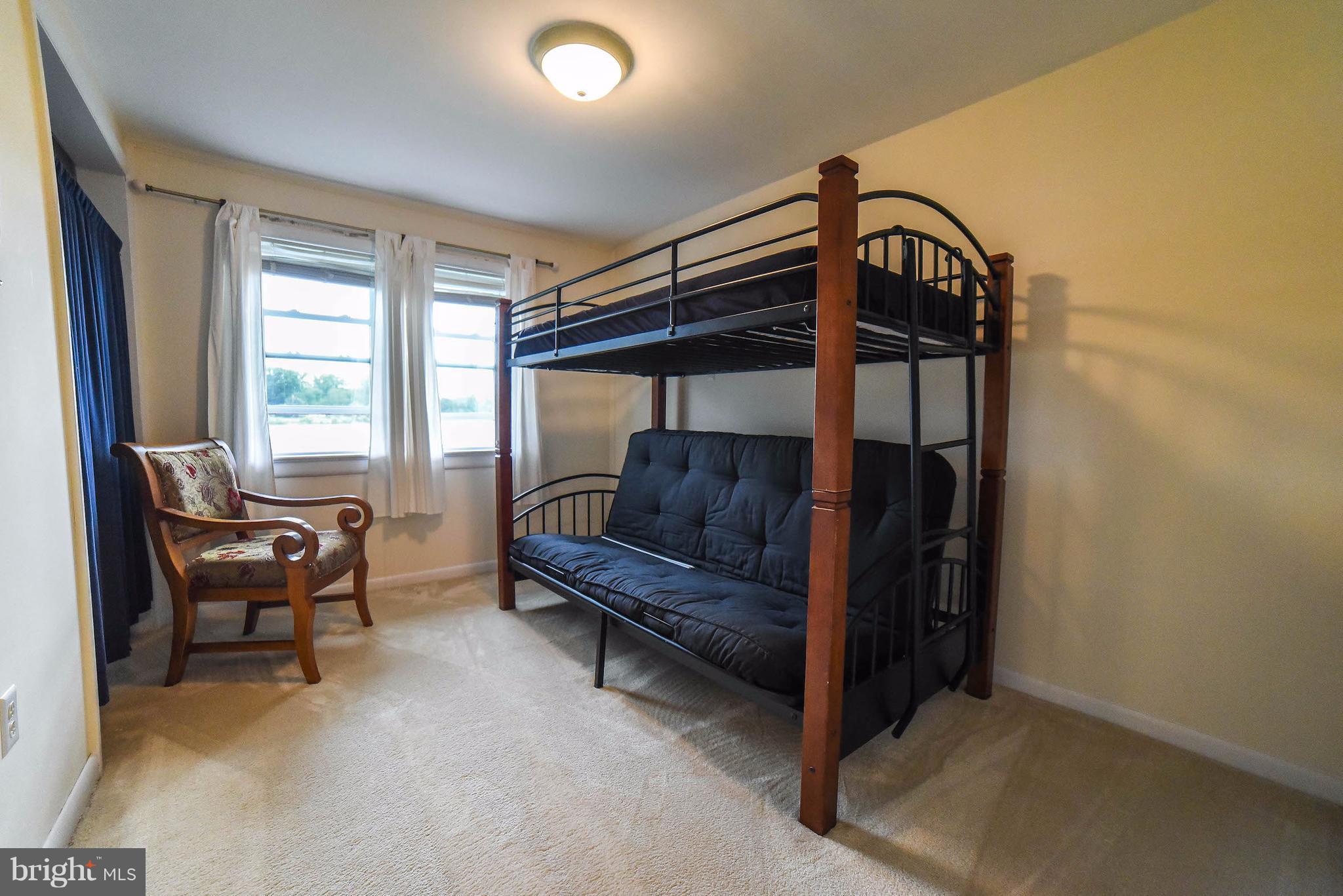 16215 Osprey Cove Ln Ridge Ridge, MD 20680 - Photo 25 of 30 a bedroom with furniture and a window