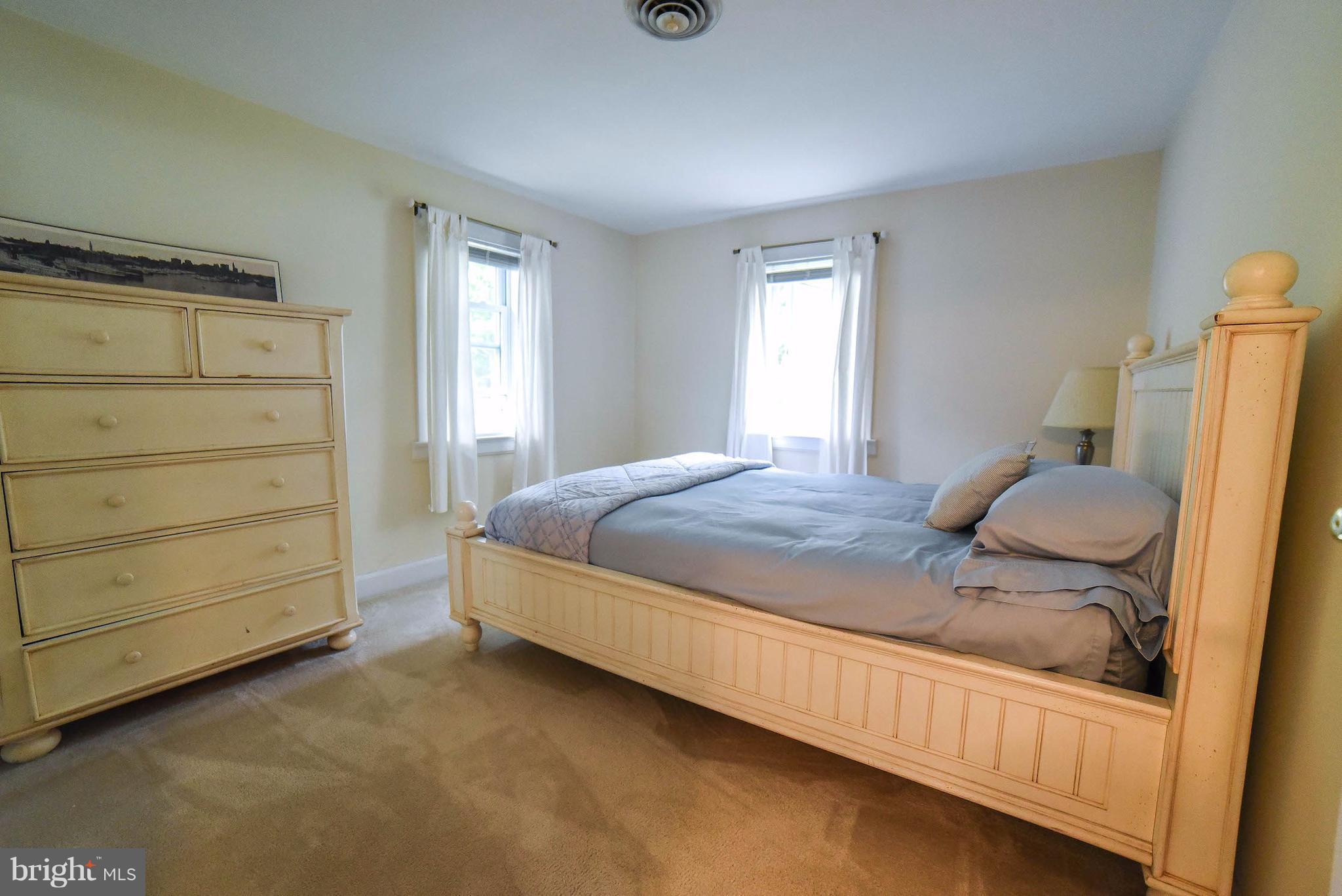16215 Osprey Cove Ln Ridge Ridge, MD 20680 - Photo 26 of 30 a bedroom with a bed and a window