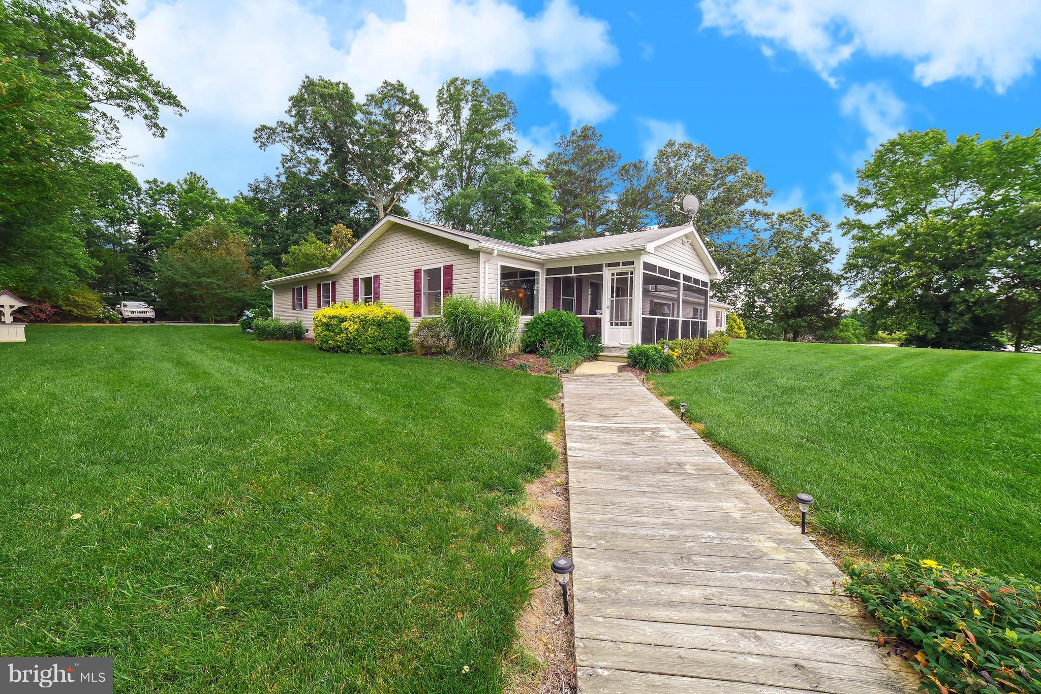 16215 Osprey Cove Ln Ridge Ridge, MD 20680 - Photo 7 of 30 a front view of a house with yard