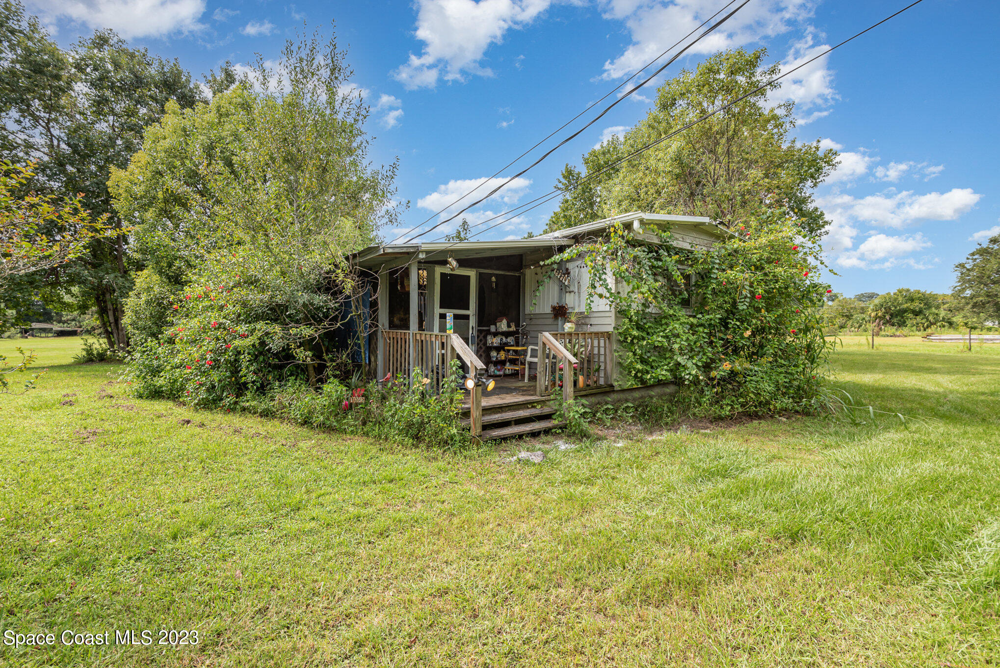 4173 Aurantia Road Mims, FL 32754 - Photo 1 of 23 a view of a chair and table in backyard of the house