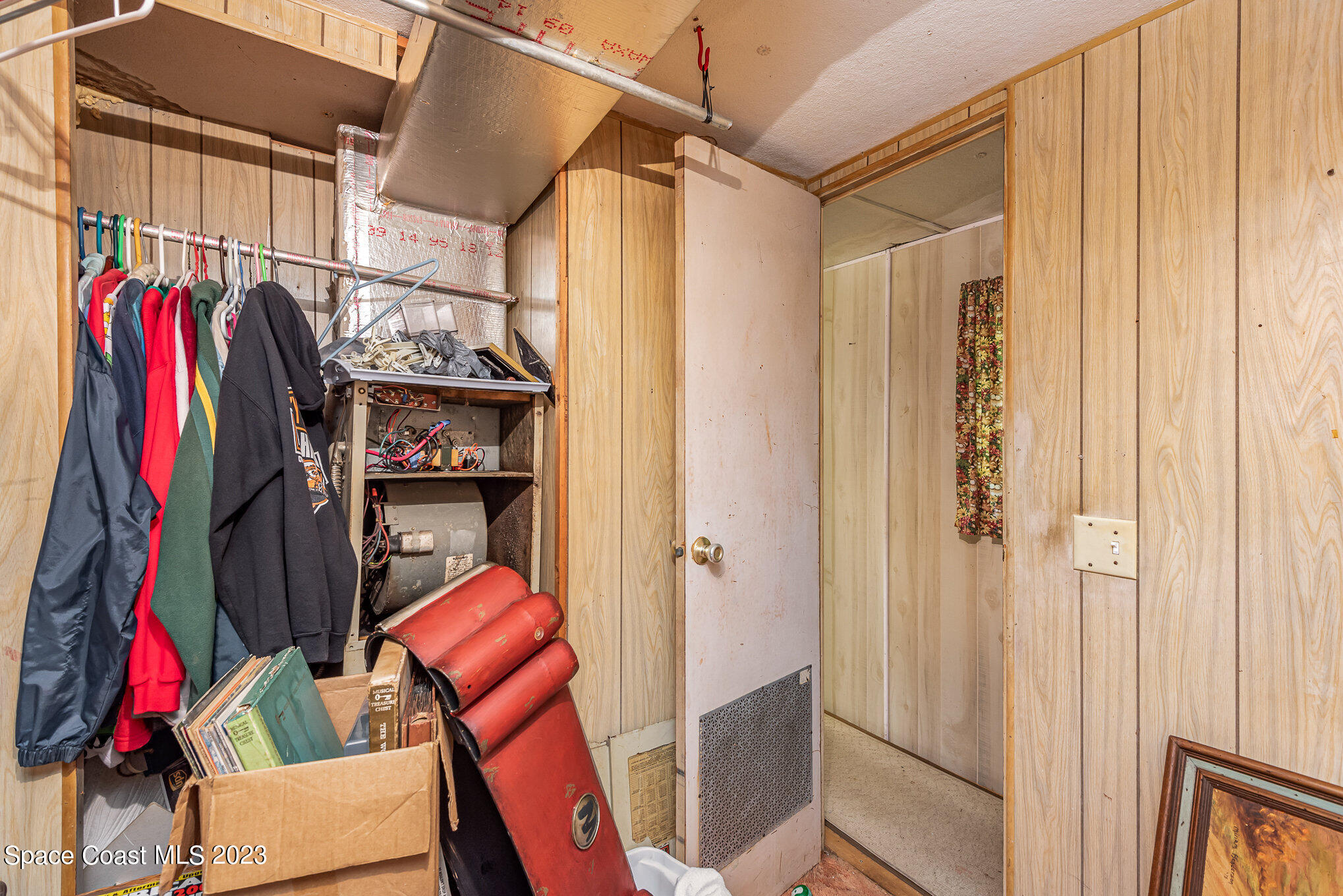 4173 Aurantia Road Mims, FL 32754 - Photo 16 of 23 a view of walk in closet with clothes and shoes