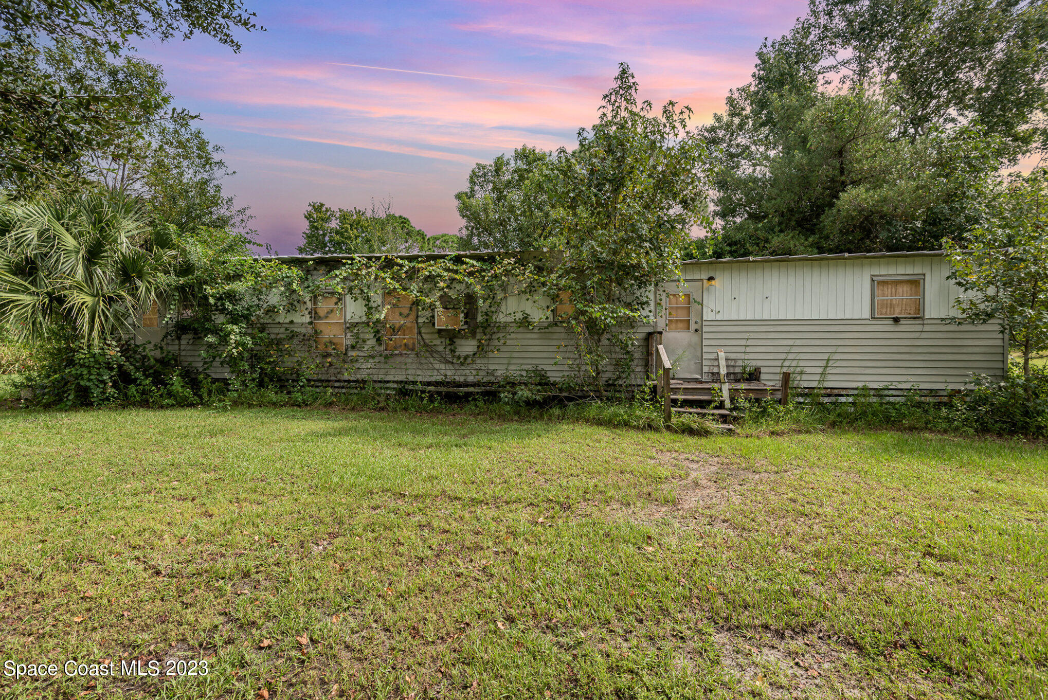 4173 Aurantia Road Mims, FL 32754 - Photo 2 of 23 a backyard of a house with lots of green space