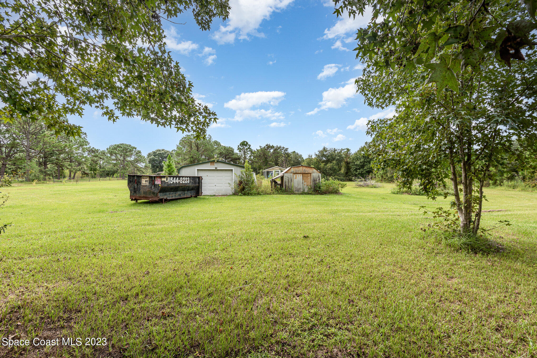 4173 Aurantia Road Mims, FL 32754 - Photo 22 of 23 a view of a green field with lots of bushes