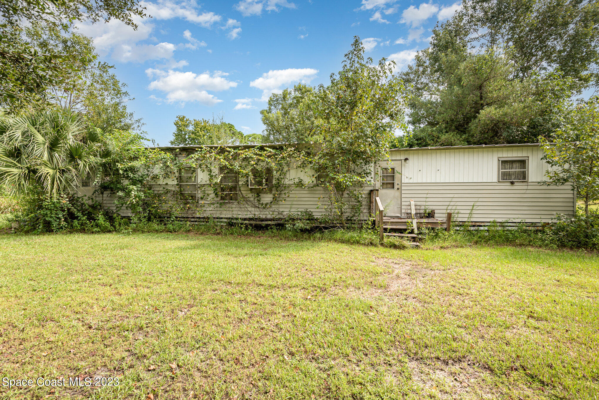 4173 Aurantia Road Mims, FL 32754 - Photo 5 of 23 a view of a swimming pool with an outdoor seating and yard
