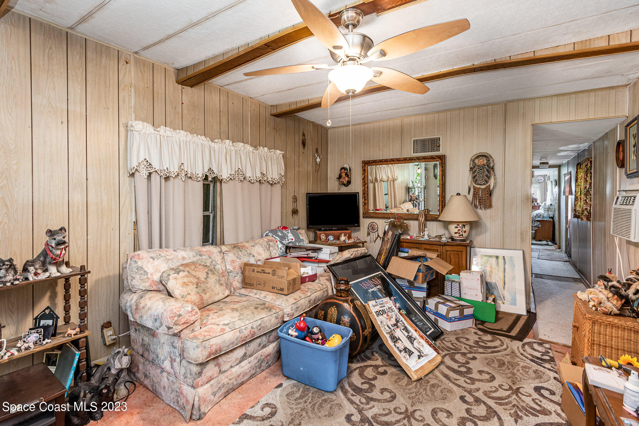 4173 Aurantia Road Mims, FL 32754 - Photo 7 of 23 a living room with furniture a flat screen tv and a window