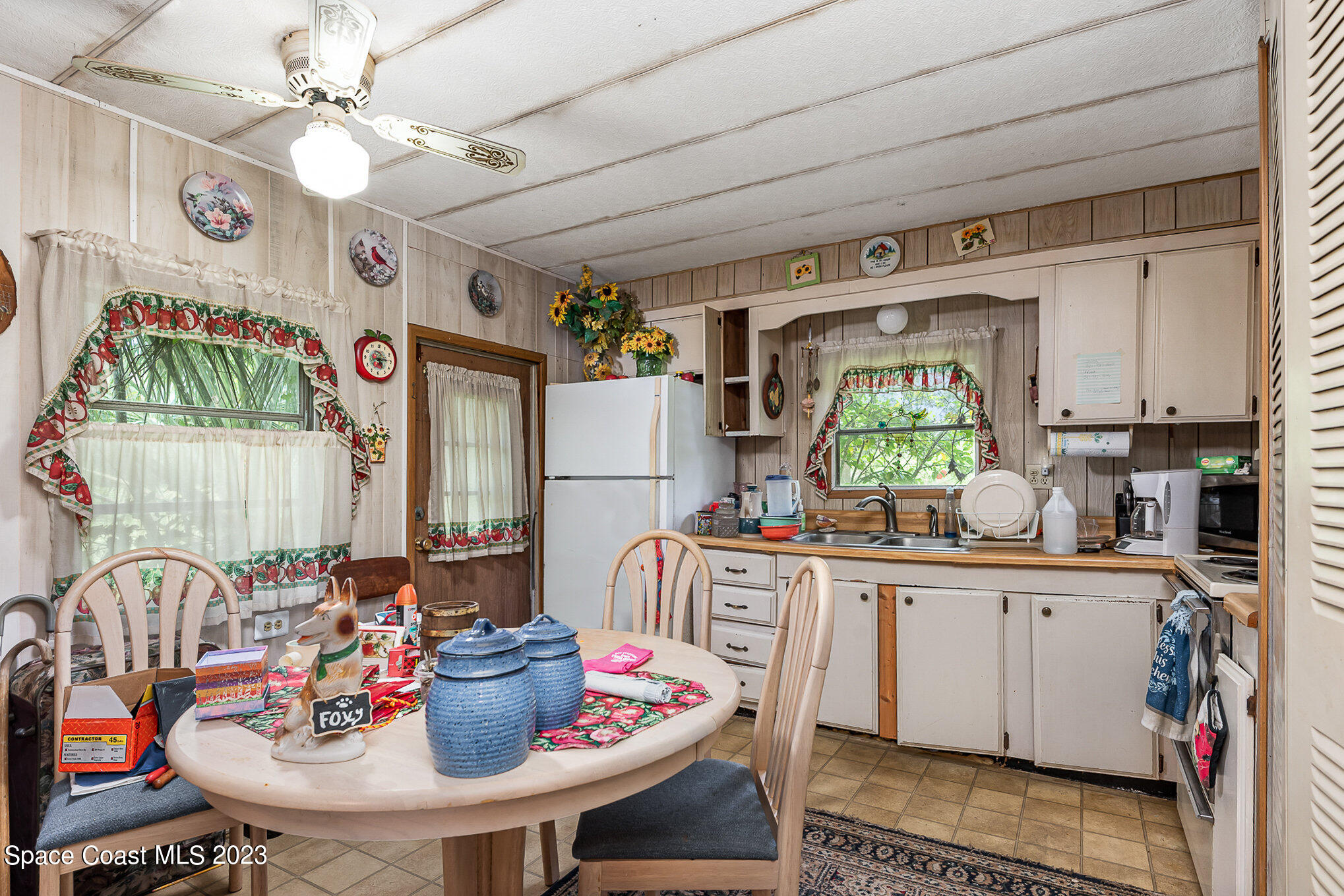 4173 Aurantia Road Mims, FL 32754 - Photo 9 of 23 a kitchen with a dining table and chairs