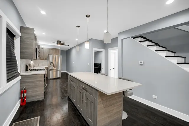 a kitchen with stainless steel appliances a stove a sink and a refrigerator