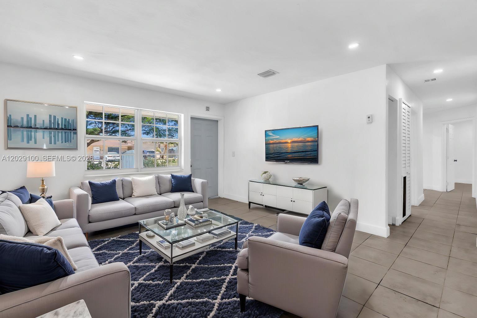 11790 Southwest 34th Street Miami, FL 33175 - Photo 5 of 56 a living room with furniture and a flat screen tv