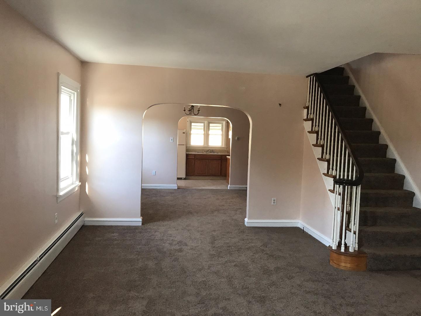 865 Lancaster Avenue Wayne, PA 19087 - Photo 2 of 13 an empty room with windows and stairs