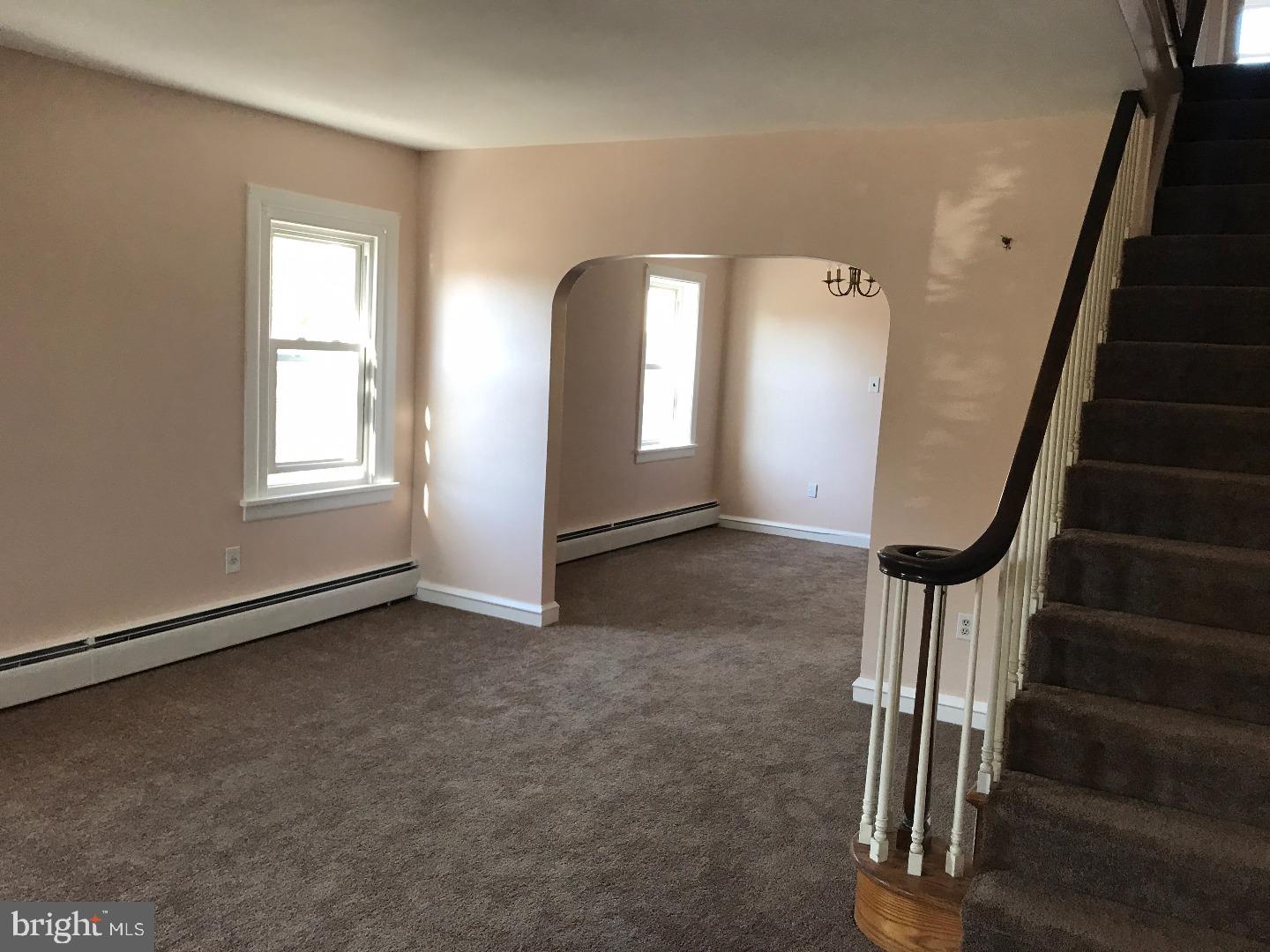 865 Lancaster Avenue Wayne, PA 19087 - Photo 3 of 13 an empty room with wooden floor and windows