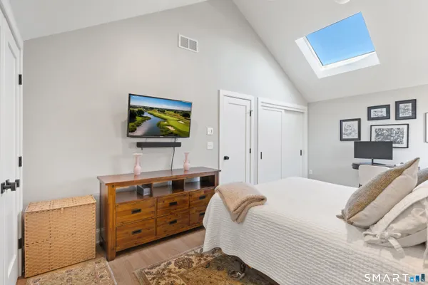 a living room with furniture a flat screen tv and a floor to ceiling window