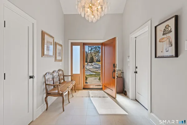 a kitchen with stainless steel appliances granite countertop a sink a stove a dining table and chairs