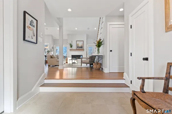a kitchen that has a lot of cabinets in it with stainless steel appliances granite countertop a sink a stove a dining table and chairs