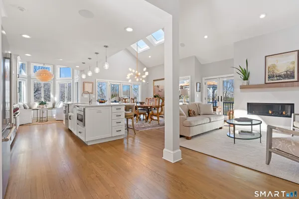 a kitchen with stainless steel appliances granite countertop a sink stove and cabinets