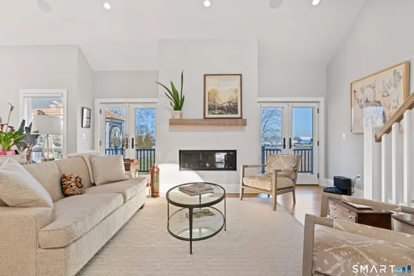 a living room with fireplace furniture and a large window