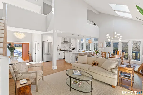 a view of a dining room with furniture wooden floor and chandelier