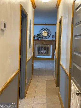 a view of a hallway with wooden floor and a fireplace
