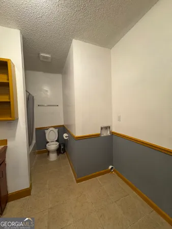 a kitchen with stainless steel appliances granite countertop a table chairs and a refrigerator
