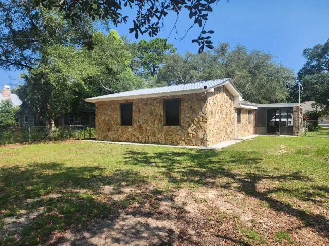 a view of a backyard with large trees