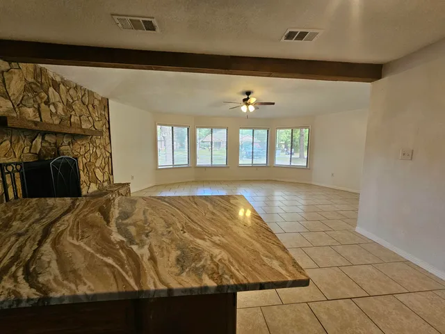 a view of a livingroom with wooden floor and windows