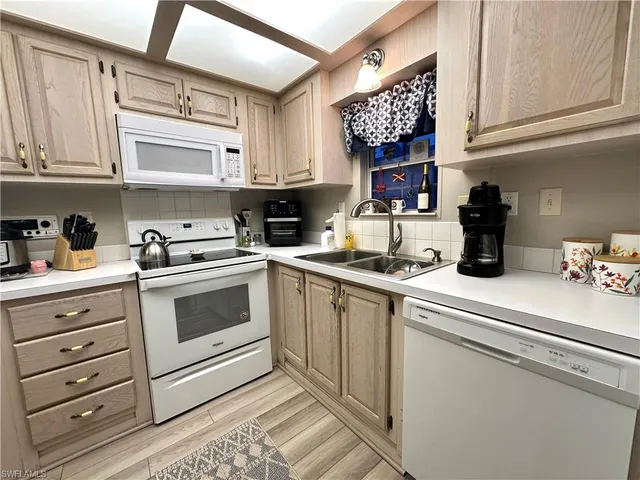 a kitchen with stainless steel appliances granite countertop a sink and cabinets
