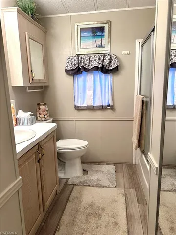 a bathroom with a sink toilet and mirror