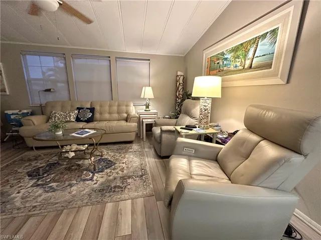 a living room with furniture fireplace and a window