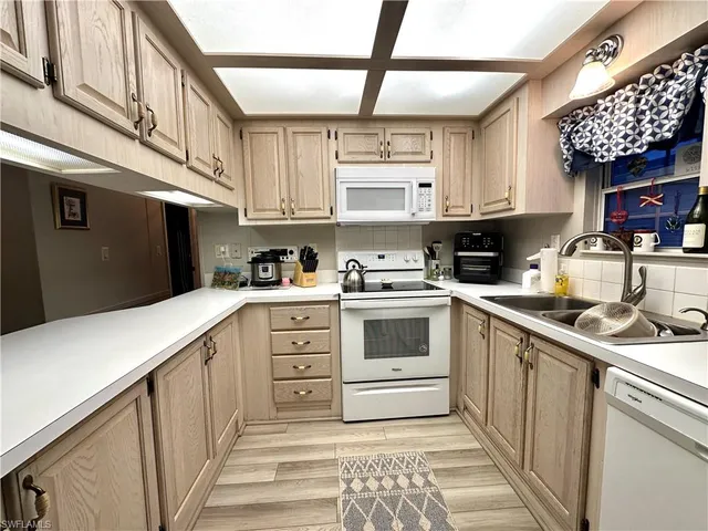 a kitchen with stainless steel appliances granite countertop a sink and cabinets