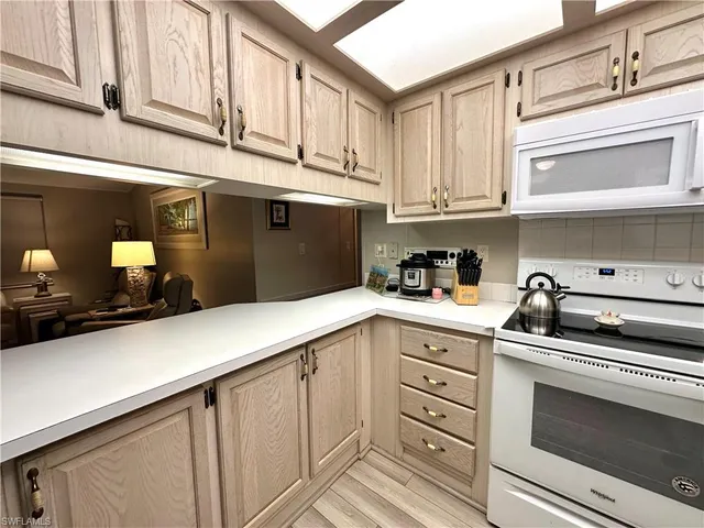 a kitchen with cabinets appliances and a sink