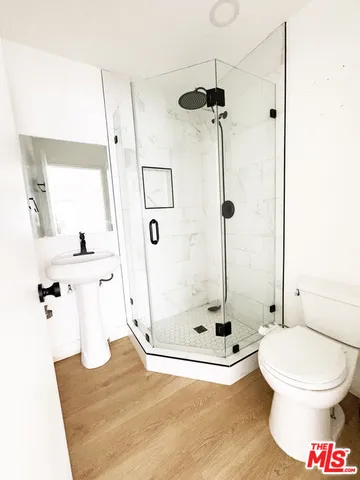 a bathroom with a toilet and a shower