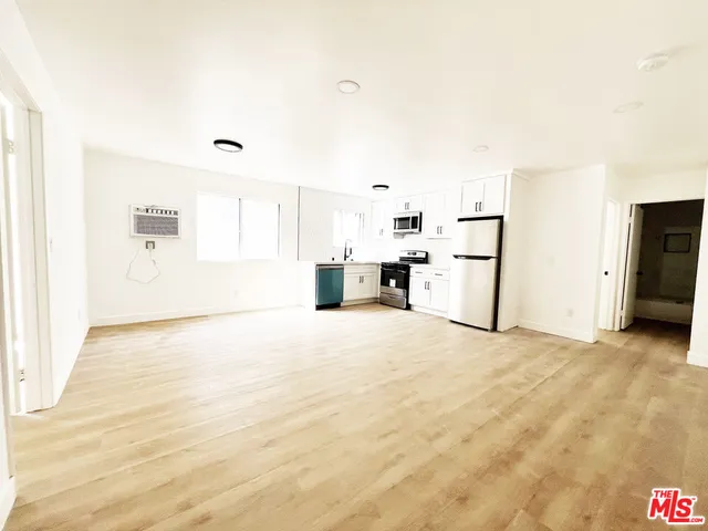 a view of a kitchen with a sink and a refrigerator