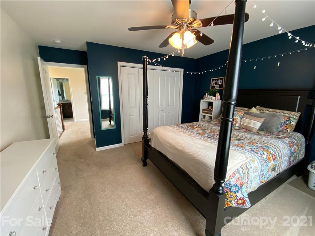 7300 Dan Rhyne Road Vale, NC 28168 - Photo 12 of 23 a spacious bedroom with a bed and a chandelier