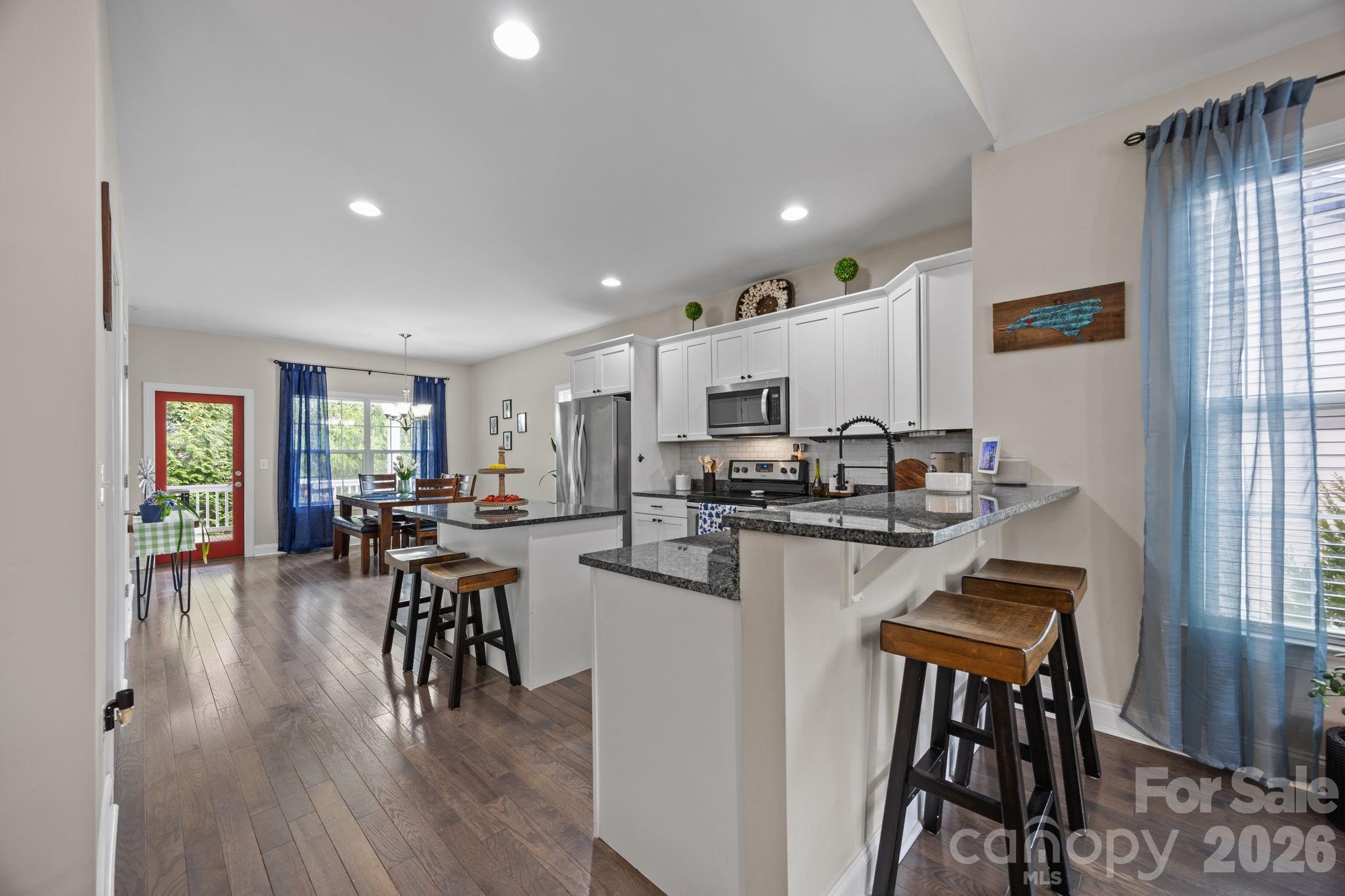 3 Dreambird Road Leicester, NC 28748 - Photo 14 of 48 a kitchen with a table chairs microwave and cabinets