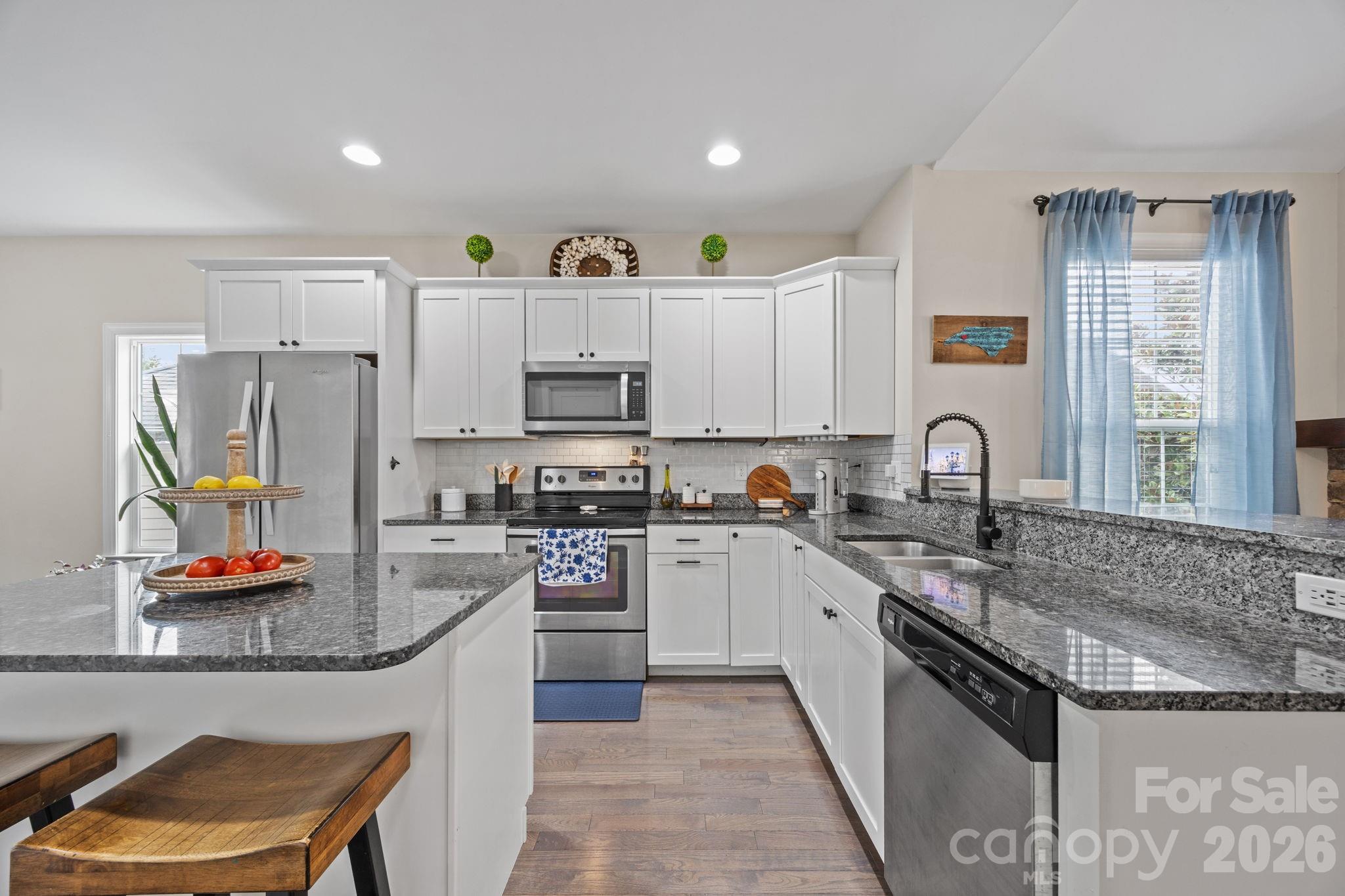 3 Dreambird Road Leicester, NC 28748 - Photo 15 of 48 a kitchen with kitchen island granite countertop a sink appliances and cabinets