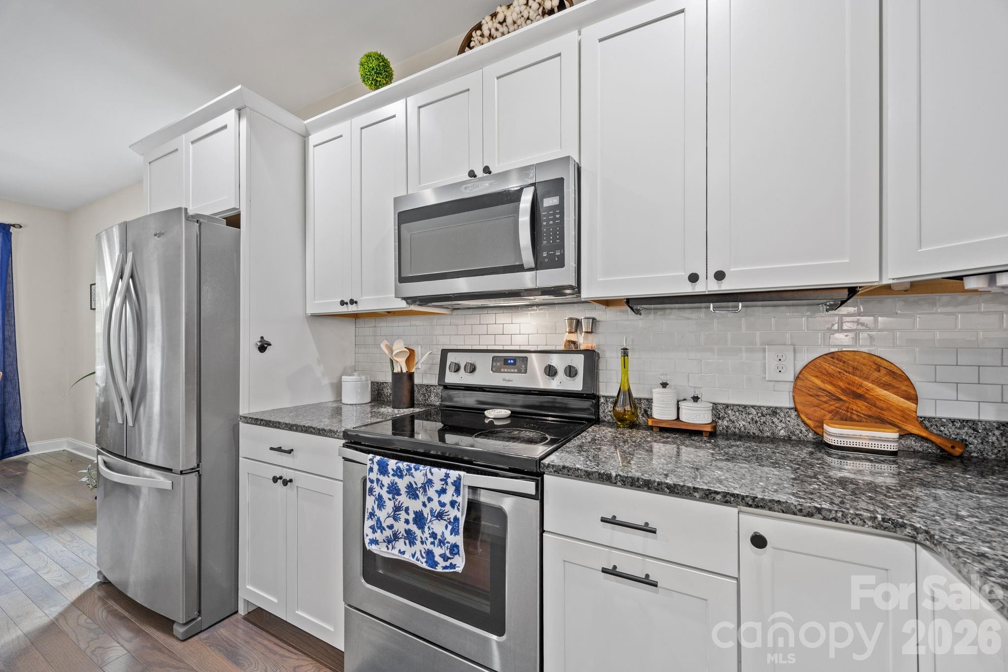 3 Dreambird Road Leicester, NC 28748 - Photo 16 of 48 a kitchen with stainless steel appliances granite countertop a stove a refrigerator and a white cabinets