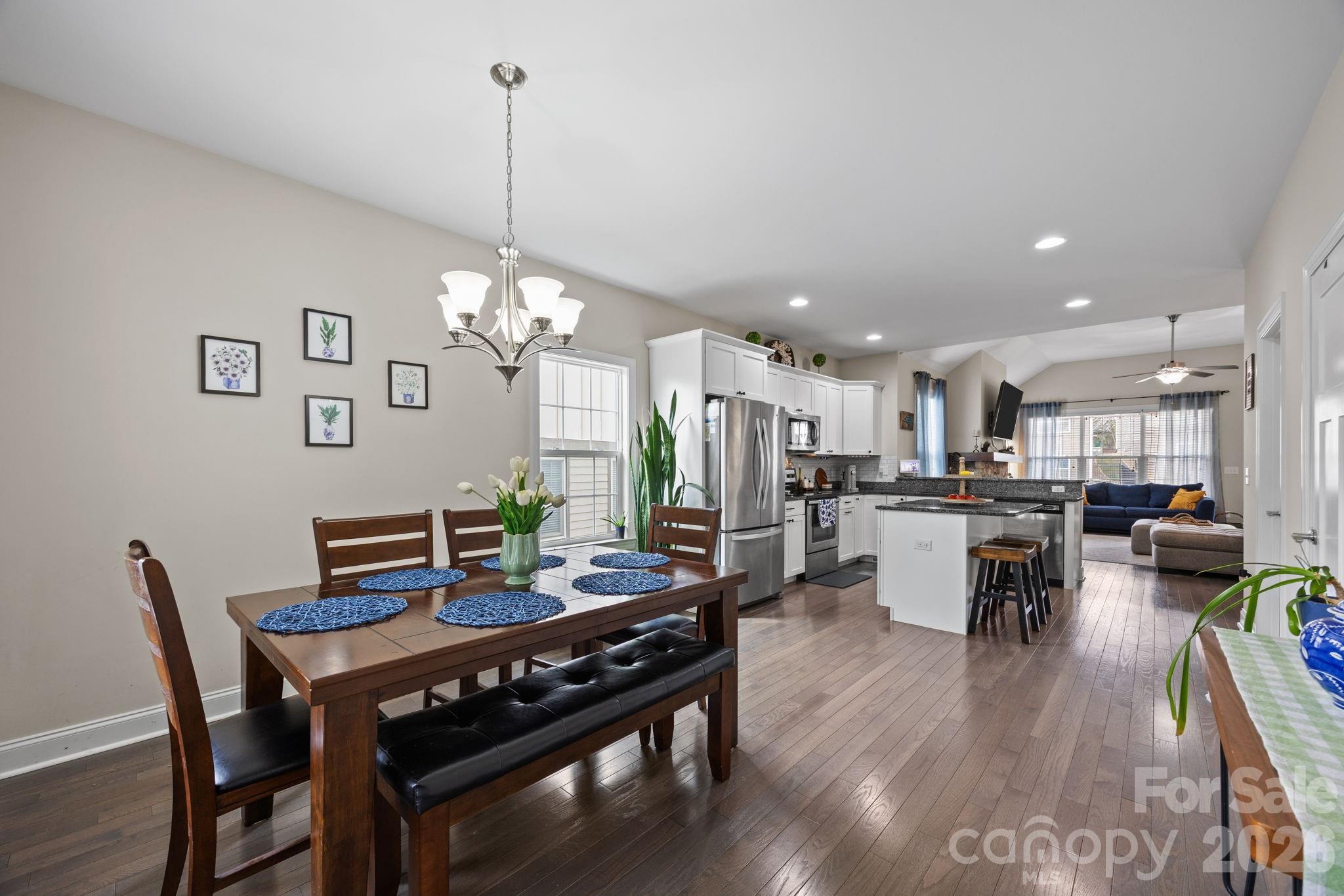 3 Dreambird Road Leicester, NC 28748 - Photo 22 of 48 a view of a dining room and livingroom with furniture wooden floor a rug a chandelier and a mirror