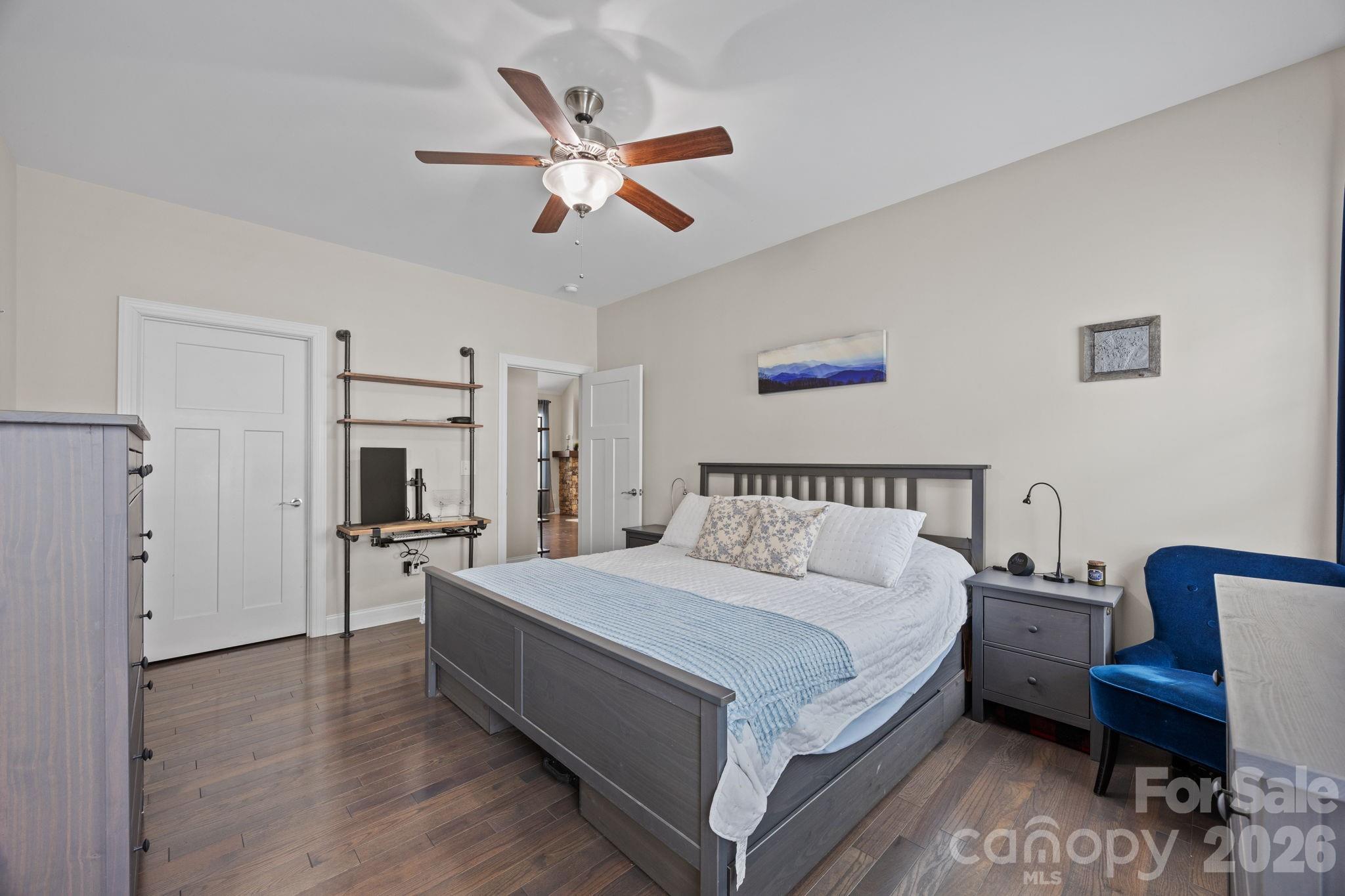 3 Dreambird Road Leicester, NC 28748 - Photo 25 of 48 a spacious bedroom with a bed a couch and a chandelier