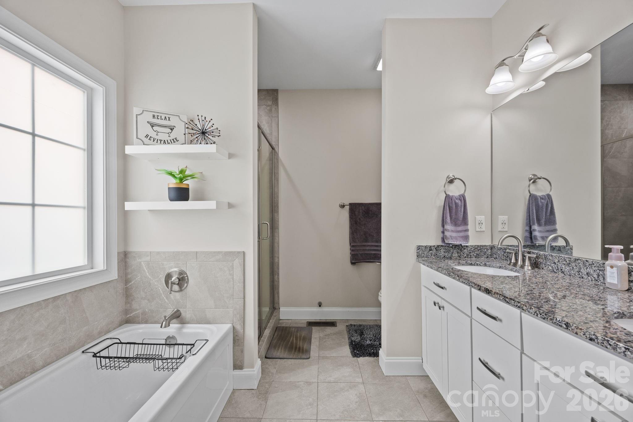 3 Dreambird Road Leicester, NC 28748 - Photo 26 of 48 a bathroom with a double vanity sink a toilet and a window