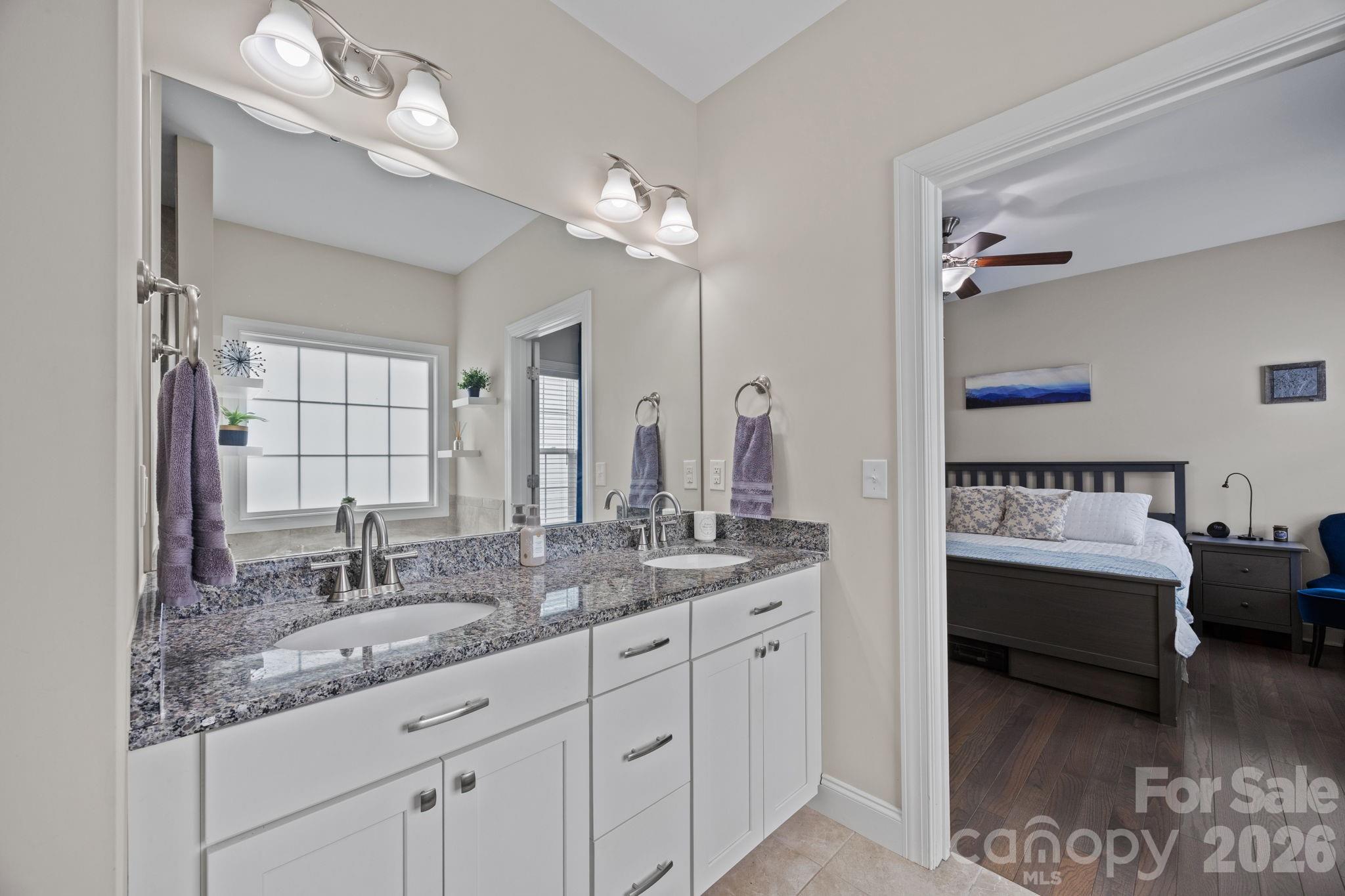 3 Dreambird Road Leicester, NC 28748 - Photo 28 of 48 a en suite bathroom with a granite countertop sink and a mirror