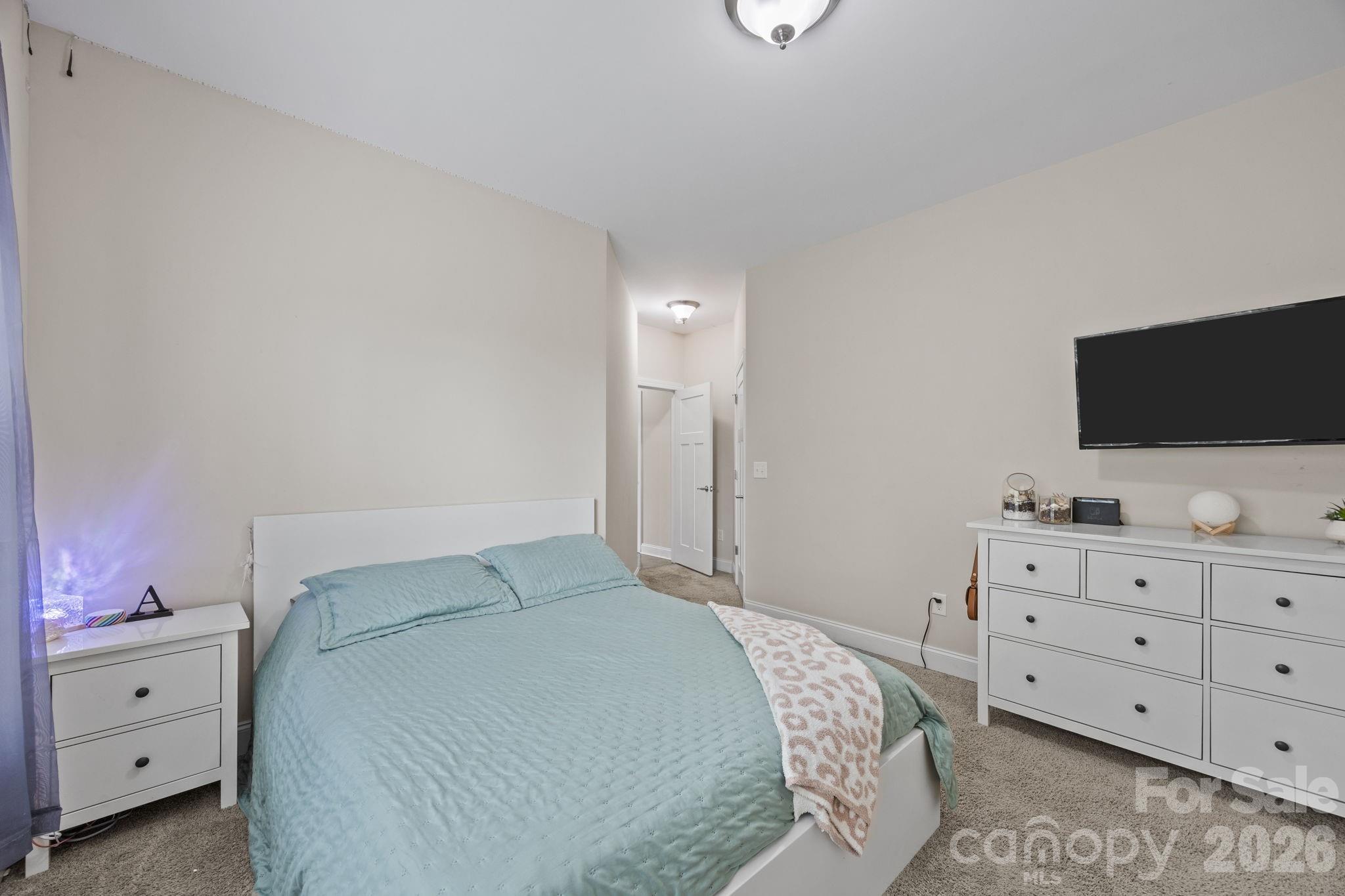 3 Dreambird Road Leicester, NC 28748 - Photo 33 of 48 a bedroom with a bed and a flat tv screen on the dresser