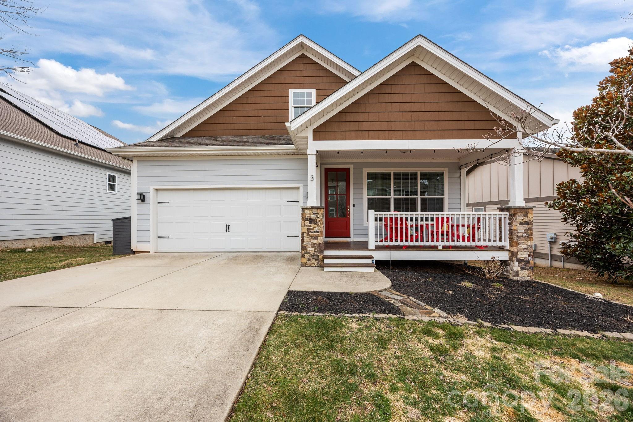 3 Dreambird Road Leicester, NC 28748 - Photo 4 of 48 a front view of a house with a yard and garage