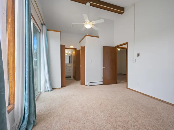 a view of a room with a ceiling fan