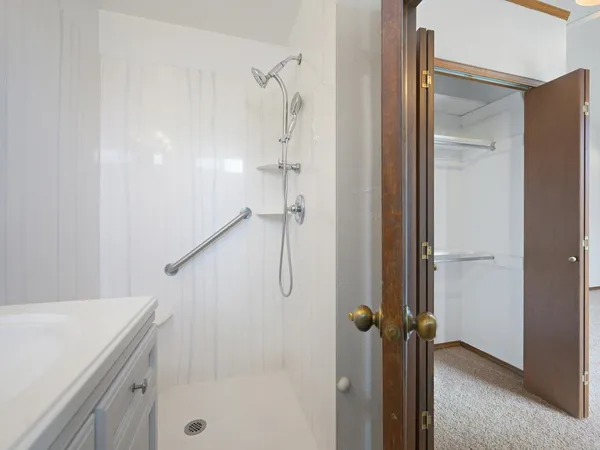 a bathroom with a shower and a sink