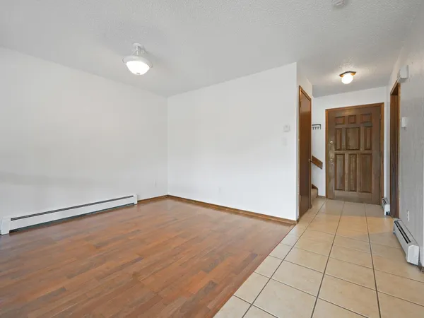 a view of an empty room with wooden floor